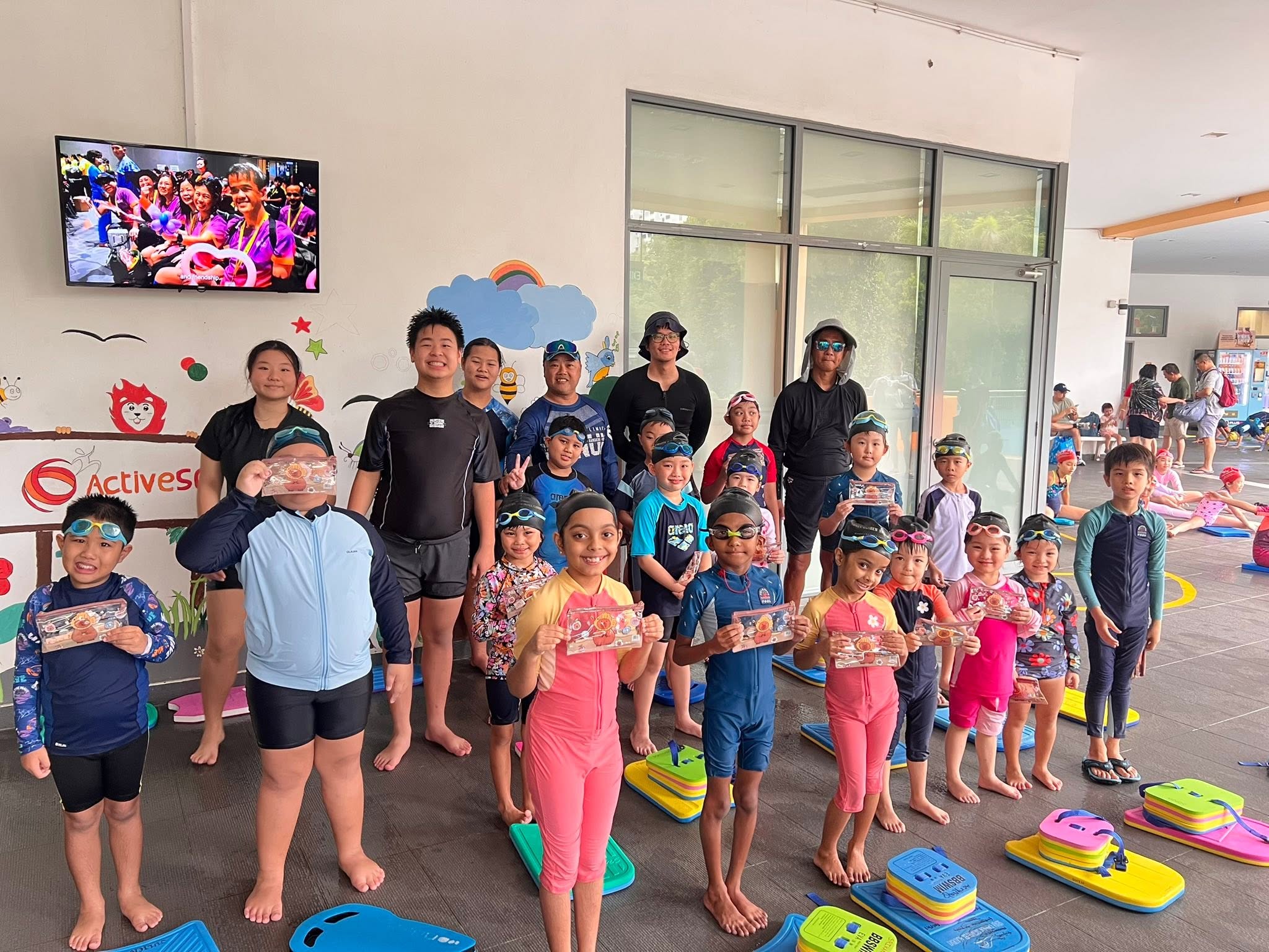 Coach guiding students during a swimming lesson